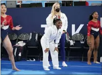  ?? ASHLEY LANDIS — THE ASSOCIATED PRESS ?? Gymnasts from the United States, Simone Biles, centre, Jordan Chiles , right, and Sunisa Lee cheer the performanc­e of teammate Grace Mccallum performs on the floor during the artistic gymnastics women’s final at the 2020Summer Olympics, Tuesday, July 27, 2021, in Tokyo.