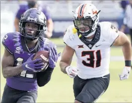  ?? RON JENKINS/AP ?? TCU’s Derius Davis (12) gets past Oklahoma State’s Kolby Harvell-Peel to score Saturday.