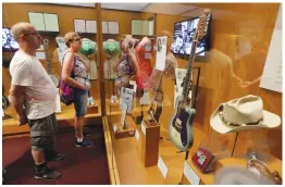  ?? — AP ?? Visitors to the Country Music Hall of Fame and Museum in Nashville, Tennessee, view the Outlaws &amp; Armadillos exhibit. The new museum exhibit offers a deeper dive behind the poets, pickers and characters that revolution­ised country music in the 1970s.