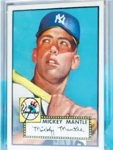  ?? DAVID ZALUBOWSKI/THE ASSOCIATED PRESS ?? A New Jersey man found five copies of this 1952 Topps Mickey Mantle card in various states of condition from the collection of cards he compiled with his brother.