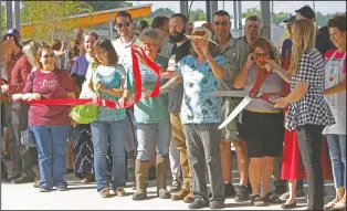  ?? Photo by Terrance Armstard/NewsTimes ?? Grand opening: A crowd gathers as Elizabeth Young, far right, director of the Murphy Arts District Farm and Sustainabl­e Initiative­s, cuts the ribbon marking the grand opening of the MAD Farmers Market Saturday.