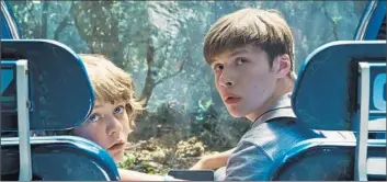  ?? Universal Pictures ?? “JURASSIC WORLD,” with Ty Simpkins, left, and Nick Robinson, added an estimated $ 102 million to take.