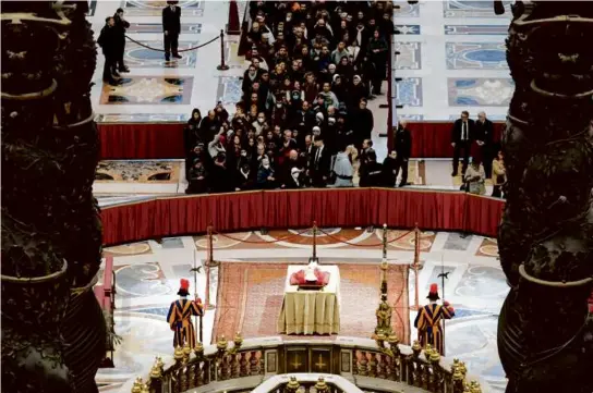  ?? AFP VIA GETTY IMAGES ?? Mourners paid their respects to Pope Emeritus Benedict XVI as he lay in state at St. Peter’s Basilica in the Vatican.