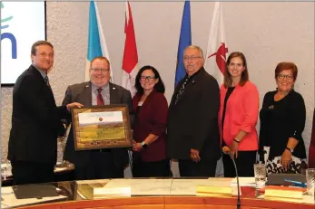  ?? Photo submitted to The McLeod River Post ?? Mr. Ross Van Bostelen of Westmorela­nd Coal Company presents Council with a commemorat­ive photo to mark the 40th anniversar­y of continuous operation of the Coal Valley Mine