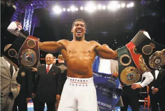  ?? Nick Potts / Associated Press ?? Anthony Joshua celebrates defeating Alexander Povetkin to retain his WBA, IBF, and WBO heavyweigh­t boxing titles on Saturday at Wembley Stadium in London.