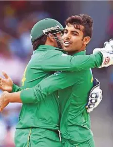  ?? AFP ?? Pakistan’s Shadab Khan (right) celebrates with Sarfraz Ahmad after dismissing West Indies’ Sunil Narine in Bridgetown.
