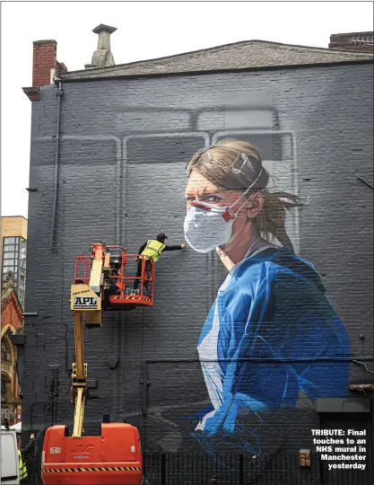  ?? Picture: DANNY LAWSON/PA ?? TRIBUTE: Final touches to an NHS mural in Manchester yesterday