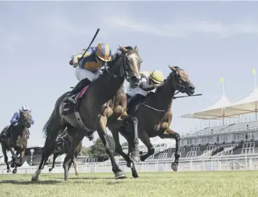  ??  ?? 0 Fancy Blue and jockey Ryan Moore, left, prove too strong in the finish as they win the Nassau Stakes.