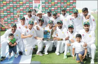  ??  ?? Pakistan cricket team celebrates at the end of day four of the second Test match between Australia and Pakistanat Sheikh Zayed Stadium in Abu Dhabi on Oct 19. (AFP)
