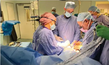  ?? ?? Surgeons perform the UK’s first womb transplant on a 34-year-old woman, at Churchill Hospital in Oxford. Photograph: Womb Transplant UK/PA