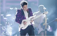  ??  ?? Bruno Mars performs Let’s Go Crazy as part of a tribute to Prince.
