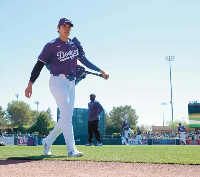  ?? ?? The Dodgers’ Shohei Ohtani walks to the dugout prior to a spring training game against the Mariners on March 13 in Phoenix.
ROSS D. FRANKLIN/AP