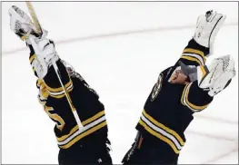  ?? MICHAEL DWYER — THE ASSOCIATED PRESS ?? The Bruins’ Linus Ullmark, left, celebrates with fellow goalie Jeremy Swayman after defeating the New York Islanders on Saturday in Boston. Ullmark stopped 26 shots.