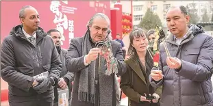  ?? Tourism Photo: Courtesy of Tangshan Culture and ?? Envoys visit Tangshan Temple Fair held in Beijing on February 24, 2024 and explore the charm of shadow puppets.