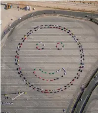  ?? Supplied photo ?? The Dubai Police have set a Guinness World Record for the formation of the largest UAE flag with 143 cars in the form of a smiley on Saturday. —