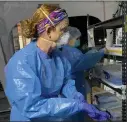  ?? SARAH BLAKE MORGAN — THE ASSOCIATED PRESS ?? Nurse Chris Rutledge suits up before entering the patient wards of a COVID-19 field hospital on Friday in Lenoir, N.C.