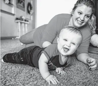  ?? Michael Ciaglo / Staff photograph­er ?? Melissa Bright plays with her 9-month-old son, Mason, in Tomball. A judge placed a $127,000 sanction against Child Protection Services after the agency unlawfully took the Brights’ children.