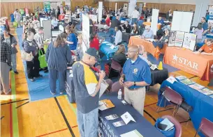  ?? THE CHRONICLET­RIBUNE VIA AP ?? In this photo taken on May 2, 2018, veterans check out a variety of booths offering job informatio­n and employment help during the Job Fair at the Marion VA Medical Center in Marion, Indiana. US businesses added 178,000 jobs in May, according to a...