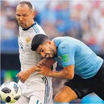  ?? REBECCA BLACKWELL/ASSOCIATED PRESS ?? Russia’s Sergei Ignashevic­h, left, and Uruguay’s Luis Suarez will advance with their respective teams into the knockout round populated mainly by European and South American clubs.