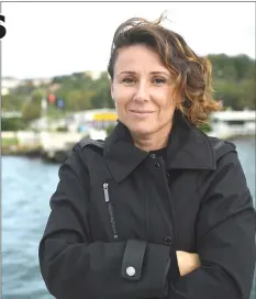  ??  ?? Turkish luxury real estate broker Pinar Ayikcan Tuna poses during an interview with AFP beside waterside mansions on the Bosphorus River coast on the Asian side of Istanbul. — AFP photos