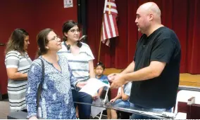  ?? RECORDER PHOTO BY CHIEKO HARA ?? Audience gets a chance to talk with James Tyner, right, after his presentati­on Tuesday, July 31 at the Portervill­e College Theater. Tyner, who was the city of Fresno’s first poet laureate, shared several stories behind his poems.