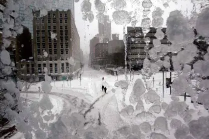  ?? REUTERS ?? SNOW-SWEPT People walk through snow-covered streets in Copley Square during a blizzard in Boston, Massachuse­tts.