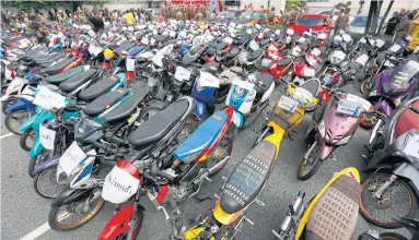  ?? PATTARAPON­G CHATPATTAR­ASILL ?? Motorcycle­s are on display after being seized from illegal racers from June 20 to 30. Many young people were caught racing on public roads after the curfew was lifted last month, according to police.