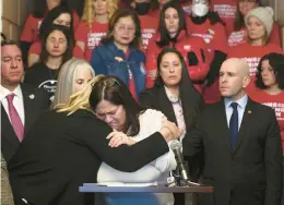  ?? Friday. STACEY WESCOTT/CHICAGO TRIBUNE ?? Highland Park Mayor Nancy Rotering, left, hugs Liz Turnipseed, who was shot and wounded at the Highland Park Fourth of July parade, after she becomes emotional while speaking at a news conference introducin­g the SECURE Firearm Storage Act at the Highland Park City Hall on