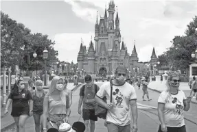  ?? JOE BURBANK/ORLANDO SENTINEL VIA TNS ?? Attendance has been down since the reopening of the Magic Kingdom at Walt Disney World in Florida on July 11.