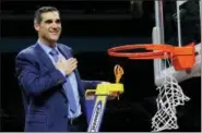  ?? DAVID J. PHILLIP — THE ASSOCIATED PRESS ?? Villanova head coach Jay Wright flashes his logo after cutting down the net after the Wildcats defeated Michigan 79-62 in the NCAA championsh­ip game last Monday in San Antonio.