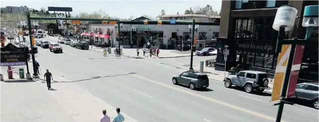  ??  ?? TODAY: Fourth Street S. W. in Calgary is slowly getting back to business.