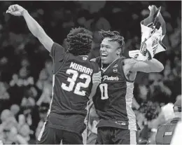  ?? ?? Saint Peter’s Jaylen Murray, left, and Latrell Reid celebrate after beating Purdue in the Sweet 16 on Friday in Philadelph­ia.