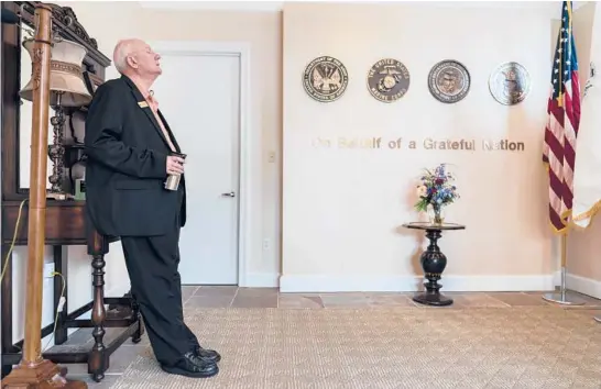  ?? CAROLYN KASTER/AP PHOTOS ?? Air Force Mortuary Affairs Operations Senior Chaplain David Sparks pauses for a quiet moment June 21 at Dover Fisher House at Dover Air Force Base, Delaware. Dover Fisher House provides short-term, on-base lodging to families who travel to Dover Air Force base to witness the dignified transfer of their loved ones.