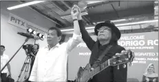  ?? (PITX) inaugurati­on. (Malacañang photo) ?? President Rodrigo Duterte raises the hand of singer Freddie Aguilar on the sidelines of the Parañaque Integrated Terminal Exchange