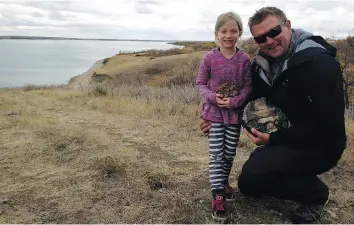  ?? SUPPLIED PHOTOS/ JON GANSHORN ?? Lily Ganshorn and her father, Jon, show off some of the favourite fossils they uncovered during their summer excavation­s at Lake Diefenbake­r.
