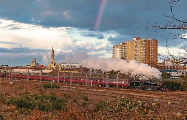  ?? ALAN WEAVER ?? LMS ‘Black Five’ No. 44871 heads past St James bridge, south of Doncaster station, with the Railway Touring Company’s ‘The White Rose’ from King’s Cross to York and return on February 24. The sun faded as a downpour began and a rainbow appeared.