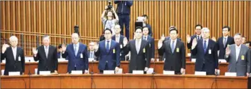  ?? JUNG YEON-JE/AFP ?? The publicity-shy heads of South Korea’s largest conglomera­tes faced their worst nightmare yesterday as they were publicly grilled about possible corrupt practices before an audience of millions.