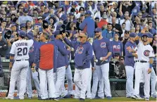  ?? DAVID BANKS/THE ASSOCIATED PRESS ?? The Chicago Cubs acknowledg­e their fans after the last regular season game Sunday against the Cincinnati Reds in Chicago. The Reds defeated the Cubs 3-1.