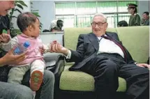  ?? NIU SHUPEI / FOR CHINA DAILY ?? Former U.S. secretary of state Henry Kissinger during a visit to a villager’s home in Xuchang, Henan province, on May 12, 2005.