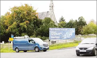  ??  ?? Traffic passes a Brexit Border poster on a road between Newry in Northern Ireland and Dundalk in the Irish Republic, on Oct 9. UK’s automation is picking up as flow of European workers slow ahead of Brexit.