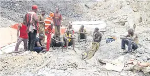  ??  ?? Artisanal miners sit outside a cobalt mine pit in Tulwizembe, Katanga province, Democratic Republic of Congo on Nov 25, 2015.