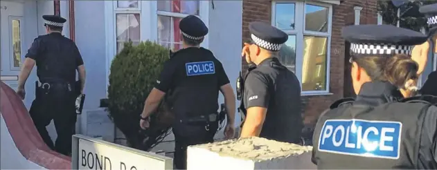  ??  ?? Police raid an address in Ashford as part of a countywide crackdown on modern day slavery - four women were rescued from a suspected brothel