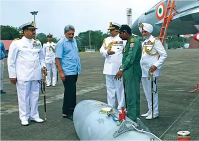  ??  ?? The Union Minister for Defence, Manohar Parrikar, being briefed by Captain Theophilis, Commanding Officer INAS 303, about
MiG-29K fighter aircraft, during his visit to the Naval Air Station INS Hansa, at Goa, on November 14