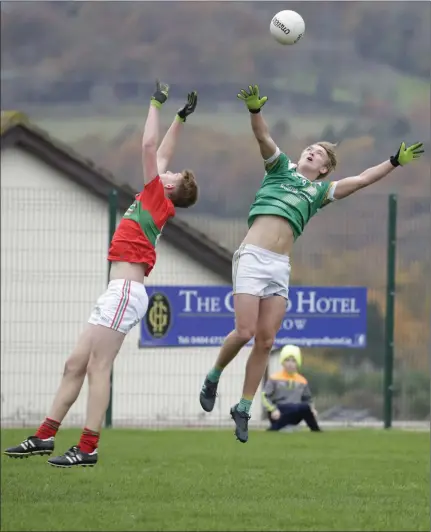  ??  ?? JT Moorehouse of Rathnew and Sean Branagan of St Nicholas battle for a high battle during their U-20 Championsh­ip match.