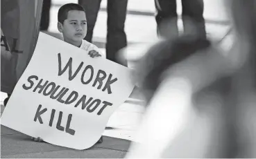  ?? RICARDO B. BRAZZIELL/AMERICAN-STATESMAN FILE ?? Sixto Jaimes, Jr. joined his father and about 500 constructi­on workers and supporters who marched to the Texas State Capitol on March 2, 2011. They carried 138 coffins to signify the 138 constructi­on workers who died on the job in Texas in 2009.