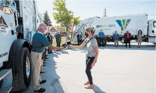  ?? JULIE JOCSAK
TORSTAR ?? Niagara Region staffer Ashley Northcotte hands out a hat during an event Wednesday to introduce Miller Waste Systems as one of the region’s new waste management providers.