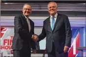  ?? MICK TSIKAS — POOL PHOTO ?? Australian Prime Minister Scott Morrison, right, and Australian opposition leader Anthony Albanese shake hands ahead of the leaders' debate in Sydney, Australia.