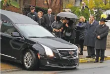  ?? Gene J. Puskar / Associated Press ?? A hearse carrying Richard Gottfried, a dentist who treated refugees and immigrants, leaves a Pittsburgh funeral home.