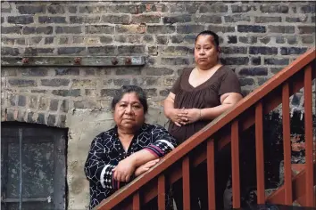  ?? Shafkat Anowar / Associated Press ?? Maria Elena Estamilla, 62, left and her daughter Esmeralda Triquiz in Chicago. Estamilla’s last full medical exam was in 2015 and she sees no options for care as a Mexican immigrant without legal permission to live in the U.S. She's not eligible for Medicare, Medicaid or Affordable Care Act coverage. As a child care worker, she didn't have employer coverage. She can't afford private insurance.