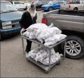  ?? ?? Food bank worker Pat Newburgh pushes a trolly packed with ground beef donated by the Saskatchew­an Stock Growers Associatio­n, Sept. 20.